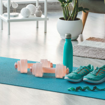 Sports equipment on yoga mat at home
